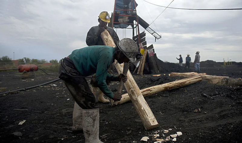Miners make wooden support beams in a coalmine in Agujita, Coahuila state, on 13 November 2012. Photograph: Yuri Cortéz/AFP/Getty Images