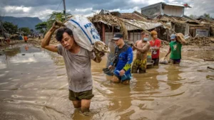 Residents of Rizal province, Philippines, carry their belonging after Typhoon Vamco hit on Nov. 14, 2020