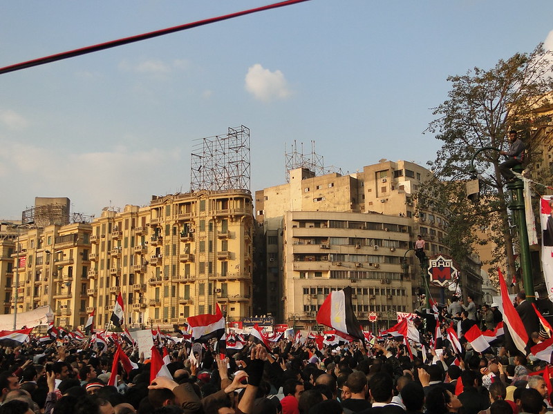 A huge crowd of demonstrators holding flags of Egypt in Tahrir Square in 2011.