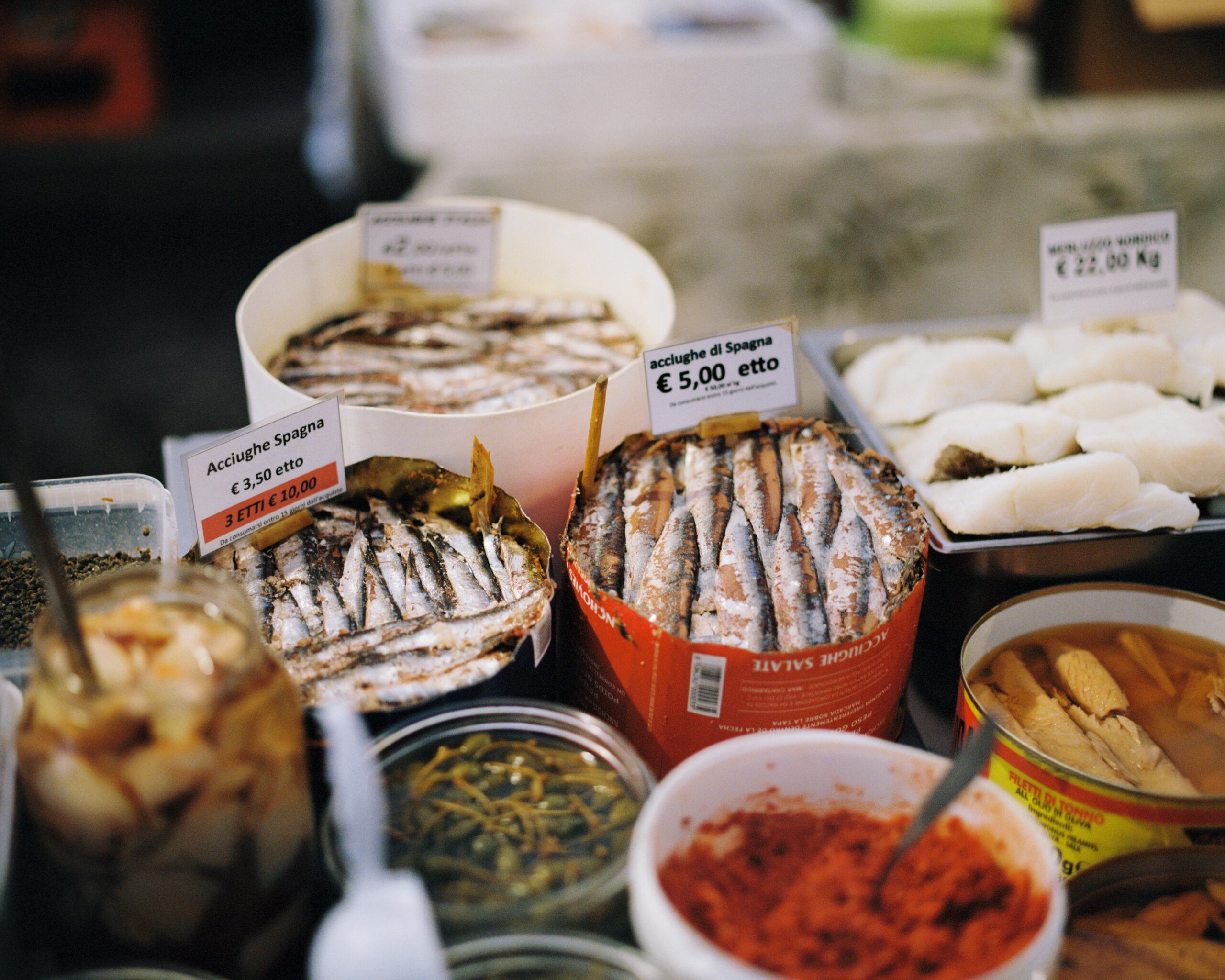 Cured fish and vegetables displayed at the Mercato di San Marco in Milano.