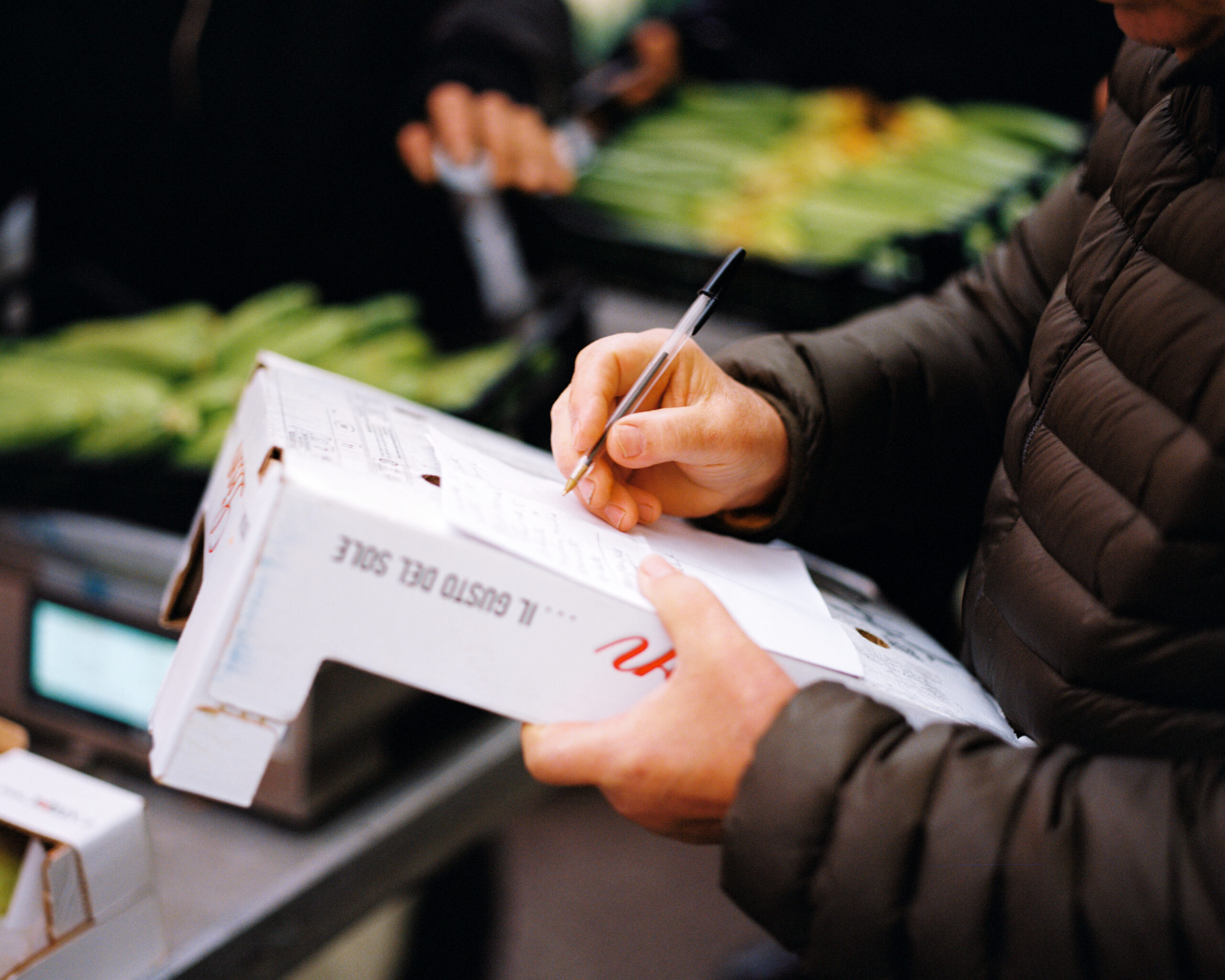 Arturo Maggi checks off his shopping list at the Mercato di San Marco in Milano.