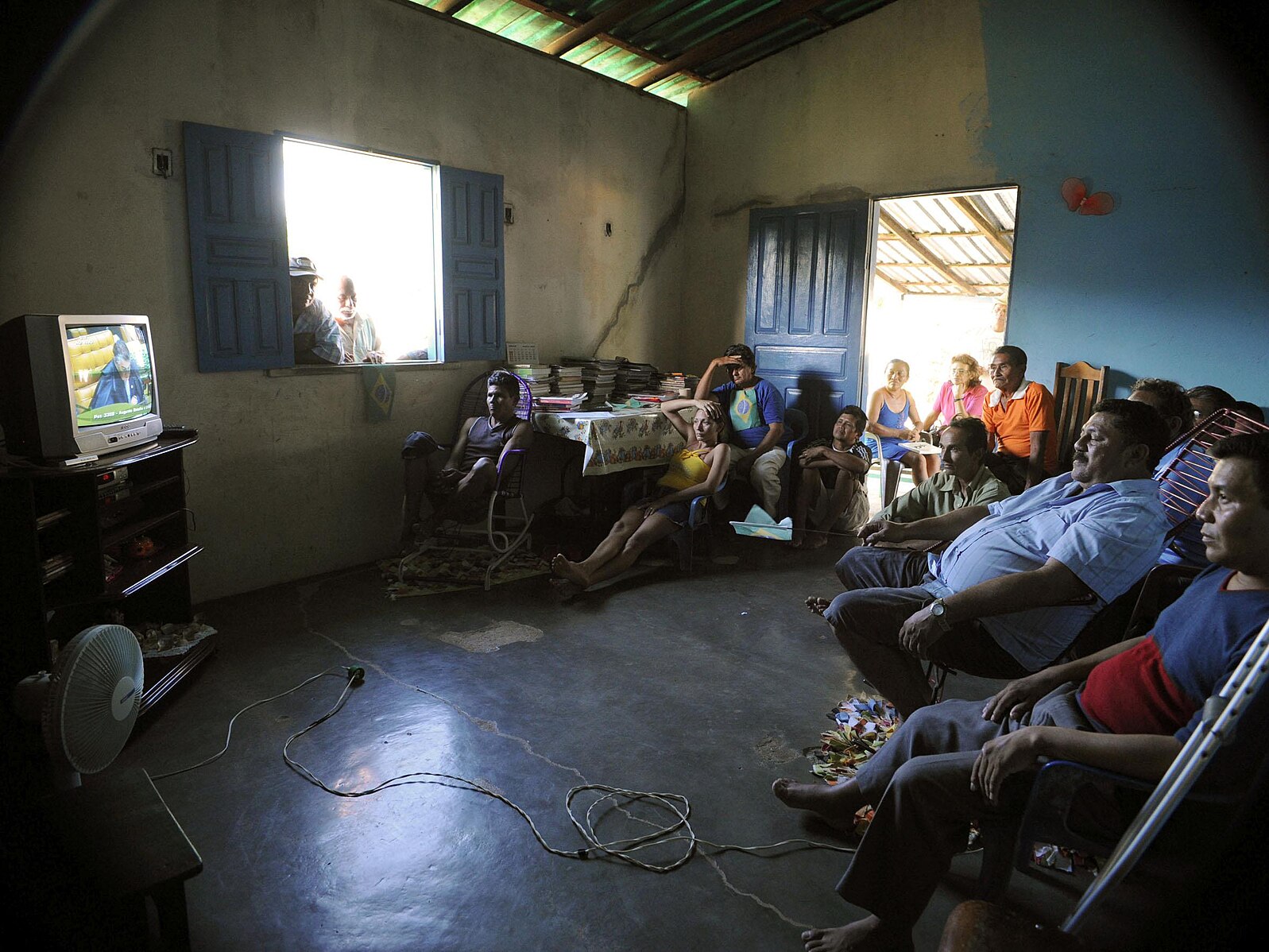 A group of indigenous people watches a telecast of the trial of the constitutionality of the demarcation of Raposa-Serra do Sol.